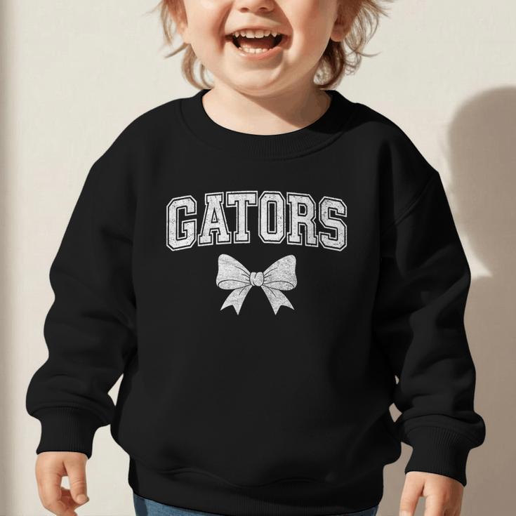 Gators High School Coquette Bow Gator Back To School Graphic Toddler Sweatshirt Gators High School Coquette Bow Gator Back To School Graphic Toddler Sweatshirt