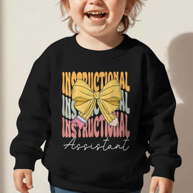 Instructional Assistant Groovy Coquette Bow Back To School Graphic Toddler Sweatshirt Instructional Assistant Groovy Coquette Bow Back To School Graphic Toddler Sweatshirt