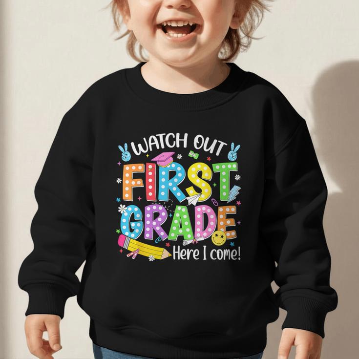 Watch Out First Grade Here I Come Back To School 1st Grade Graphic Toddler Sweatshirt Watch Out First Grade Here I Come Back To School 1st Grade Graphic Toddler Sweatshirt