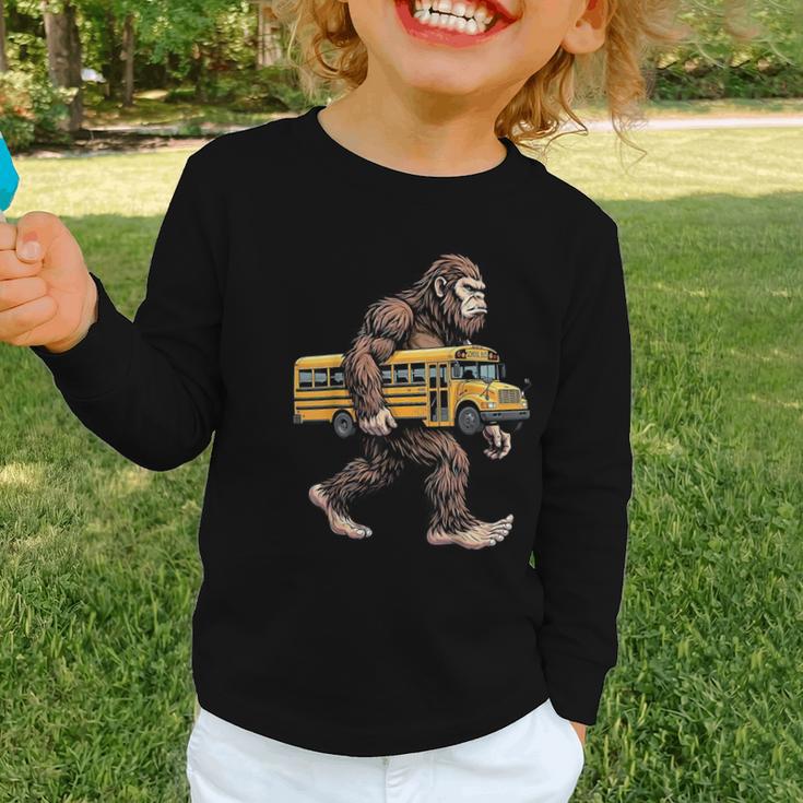 Bigfoot Carrying School Bus Sasquatch Back To School Graphic Toddler Long Sleeve Tee