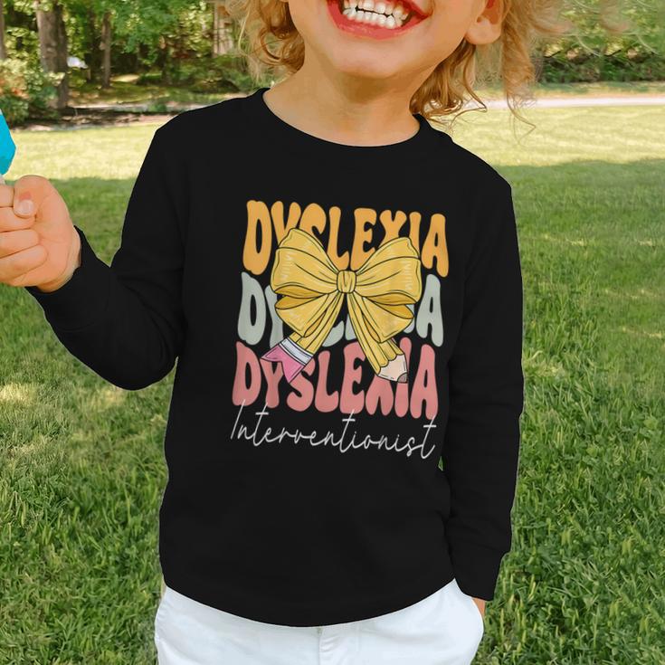 Dyslexia Interventionist Groovy Coquette Bow Back To School Graphic Toddler Long Sleeve Tee Dyslexia Interventionist Groovy Coquette Bow Back To School Graphic Toddler Long Sleeve Tee