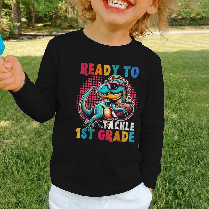 First Day Back To School 1st Grade Boys Football Dinosaur Graphic Toddler Long Sleeve Tee First Day Back To School 1st Grade Boys Football Dinosaur Graphic Toddler Long Sleeve Tee