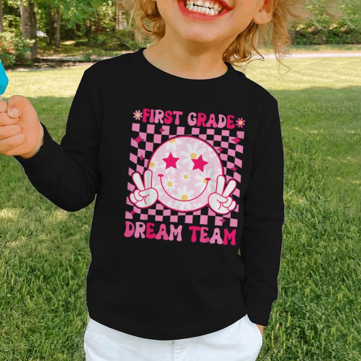 Groovy First Grade Dream Team Back To School 1st Grade Squad Graphic Toddler Long Sleeve Tee Groovy First Grade Dream Team Back To School 1st Grade Squad Graphic Toddler Long Sleeve Tee