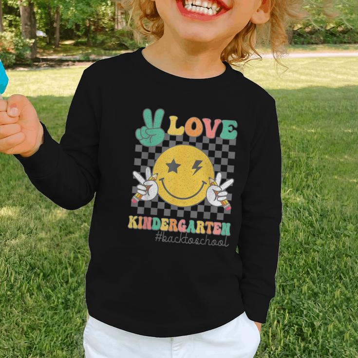 Peace Love Kindergarten Smile Face Hippie Back To School Graphic Toddler Long Sleeve Tee Peace Love Kindergarten Smile Face Hippie Back To School Graphic Toddler Long Sleeve Tee