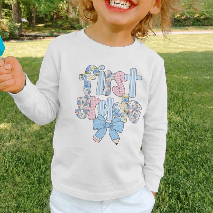First Grade Coquette Bow Pencil First Day Back To School Performance Graphic Toddler Long Sleeve Tee