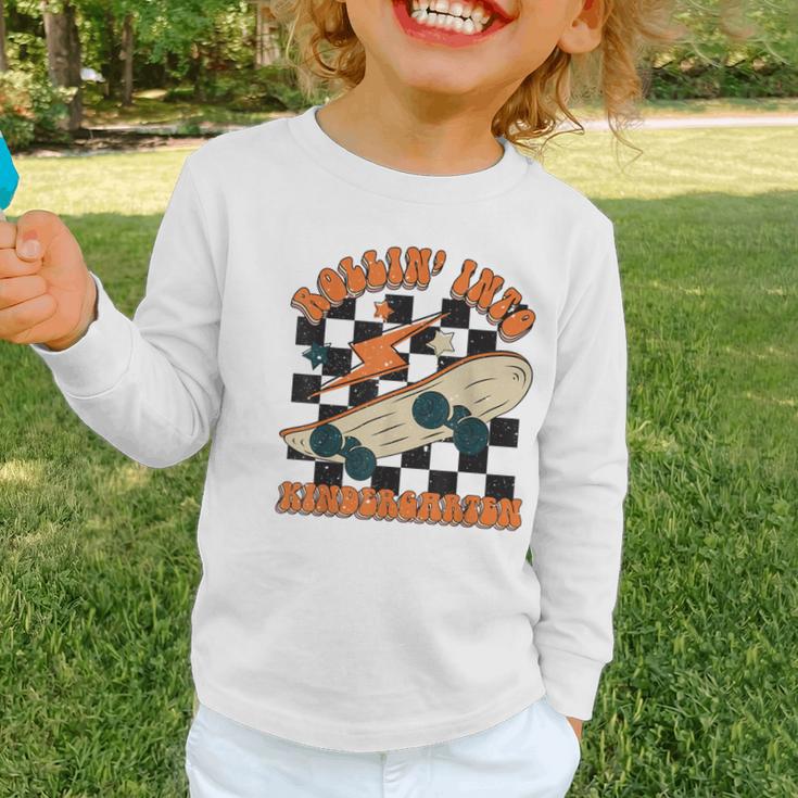 Rolling Into Kindergarten Retro Groovy Back To School Kids Graphic Toddler Long Sleeve Tee Rolling Into Kindergarten Retro Groovy Back To School Kids Graphic Toddler Long Sleeve Tee