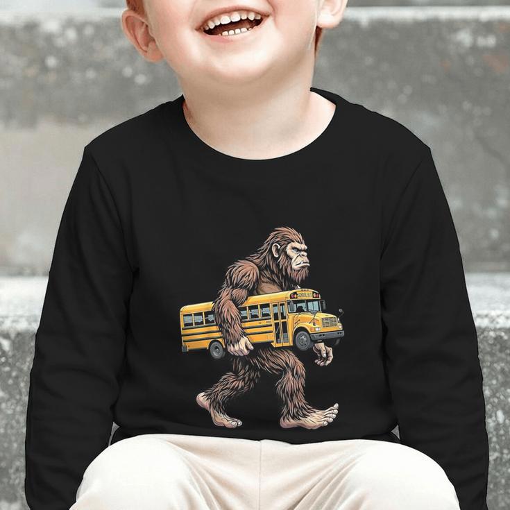 Bigfoot Carrying School Bus Sasquatch Back To School Graphic Toddler Long Sleeve Tee
