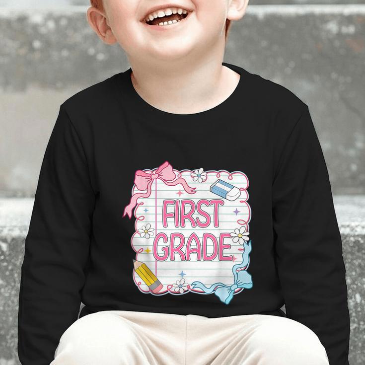 First Grade Back To School Girls Kids Coquette Bows Retro Graphic Toddler Long Sleeve Tee First Grade Back To School Girls Kids Coquette Bows Retro Graphic Toddler Long Sleeve Tee