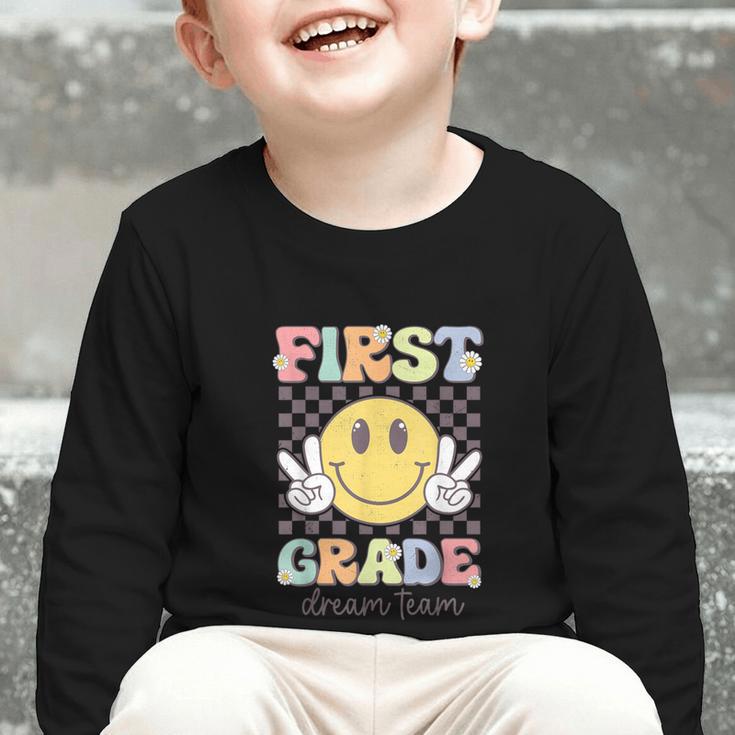 First Grade Dream Team Smile Face Back To School 1st Grade Graphic Toddler Long Sleeve Tee First Grade Dream Team Smile Face Back To School 1st Grade Graphic Toddler Long Sleeve Tee