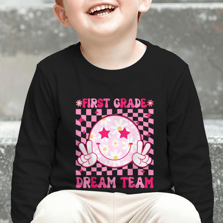 Groovy First Grade Dream Team Back To School 1st Grade Squad Graphic Toddler Long Sleeve Tee Groovy First Grade Dream Team Back To School 1st Grade Squad Graphic Toddler Long Sleeve Tee