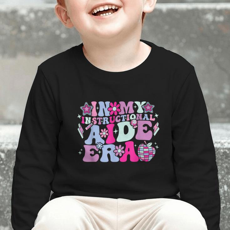 In My Instructional Aide Era Groovy Back To School Graphic Toddler Long Sleeve Tee In My Instructional Aide Era Groovy Back To School Graphic Toddler Long Sleeve Tee
