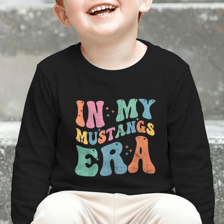 In My Mustangs Era Back To School Spirit Game Retro Groovy Graphic Toddler Long Sleeve Tee In My Mustangs Era Back To School Spirit Game Retro Groovy Graphic Toddler Long Sleeve Tee