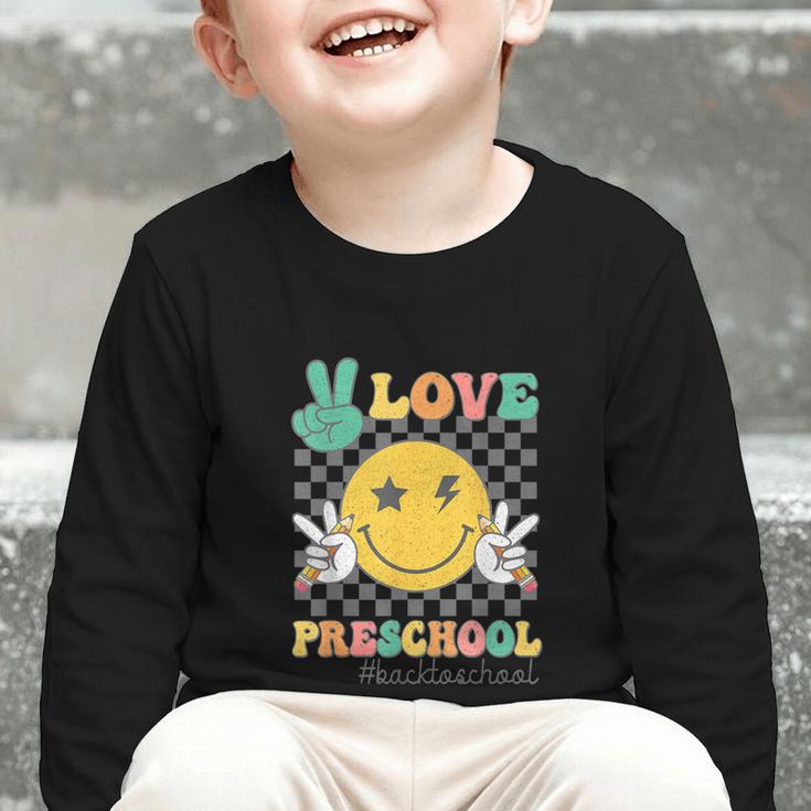 Peace Love Preschool Smile Face Back To School PRESCHOOL Graphic Toddler Long Sleeve Tee