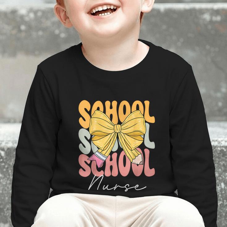 School Nurse Groovy Coquette Bow Cute Back To School Graphic Toddler Long Sleeve Tee School Nurse Groovy Coquette Bow Cute Back To School Graphic Toddler Long Sleeve Tee