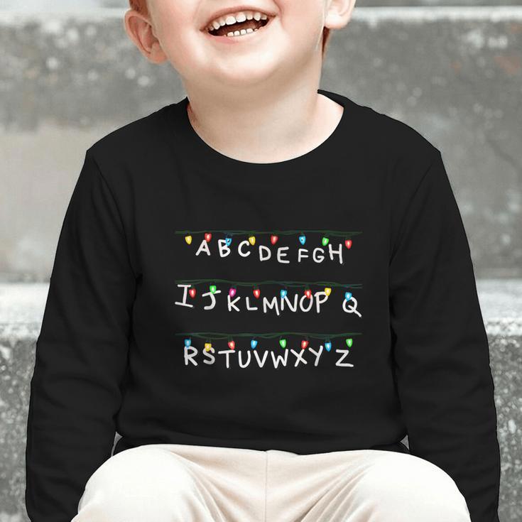 Stranger Wall Alphabet Lights Spooky Back To School Graphic Toddler Long Sleeve Tee Stranger Wall Alphabet Lights Spooky Back To School Graphic Toddler Long Sleeve Tee