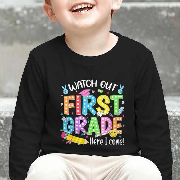Watch Out First Grade Here I Come Back To School 1st Grade Graphic Toddler Long Sleeve Tee