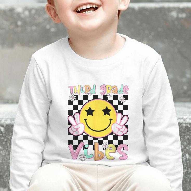 Third Grade Vibes Groovy Smile Face Back To School Girl Kid Graphic Toddler Long Sleeve Tee Third Grade Vibes Groovy Smile Face Back To School Girl Kid Graphic Toddler Long Sleeve Tee