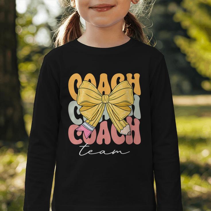 Coach Team Groovy Coquette Bow Cute Back To School Graphic Toddler Long Sleeve Tee Coach Team Groovy Coquette Bow Cute Back To School Graphic Toddler Long Sleeve Tee
