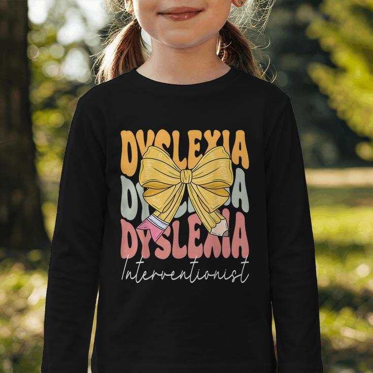 Dyslexia Interventionist Groovy Coquette Bow Back To School Graphic Toddler Long Sleeve Tee Dyslexia Interventionist Groovy Coquette Bow Back To School Graphic Toddler Long Sleeve Tee