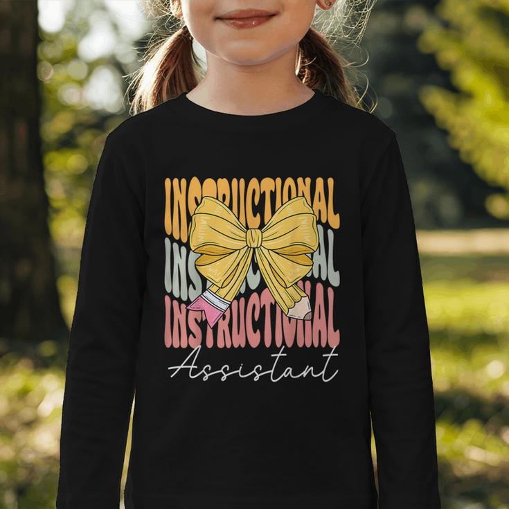 Instructional Assistant Groovy Coquette Bow Back To School Graphic Toddler Long Sleeve Tee Instructional Assistant Groovy Coquette Bow Back To School Graphic Toddler Long Sleeve Tee