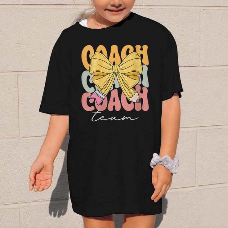 Coach Team Groovy Coquette Bow Cute Back To School Graphic Kid T-Shirt Coach Team Groovy Coquette Bow Cute Back To School Graphic Kid T-Shirt
