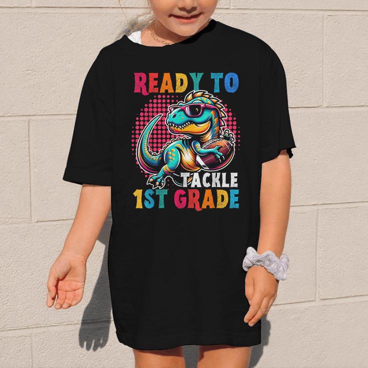 First Day Back To School 1st Grade Boys Football Dinosaur Graphic Kid T-Shirt First Day Back To School 1st Grade Boys Football Dinosaur Graphic Kid T-Shirt