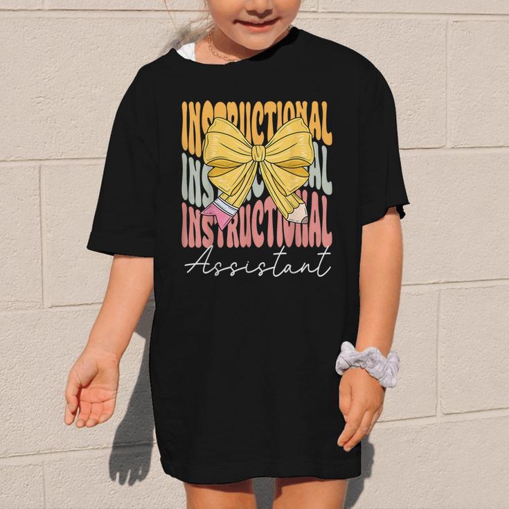 Instructional Assistant Groovy Coquette Bow Back To School Graphic Kid T-Shirt Instructional Assistant Groovy Coquette Bow Back To School Graphic Kid T-Shirt