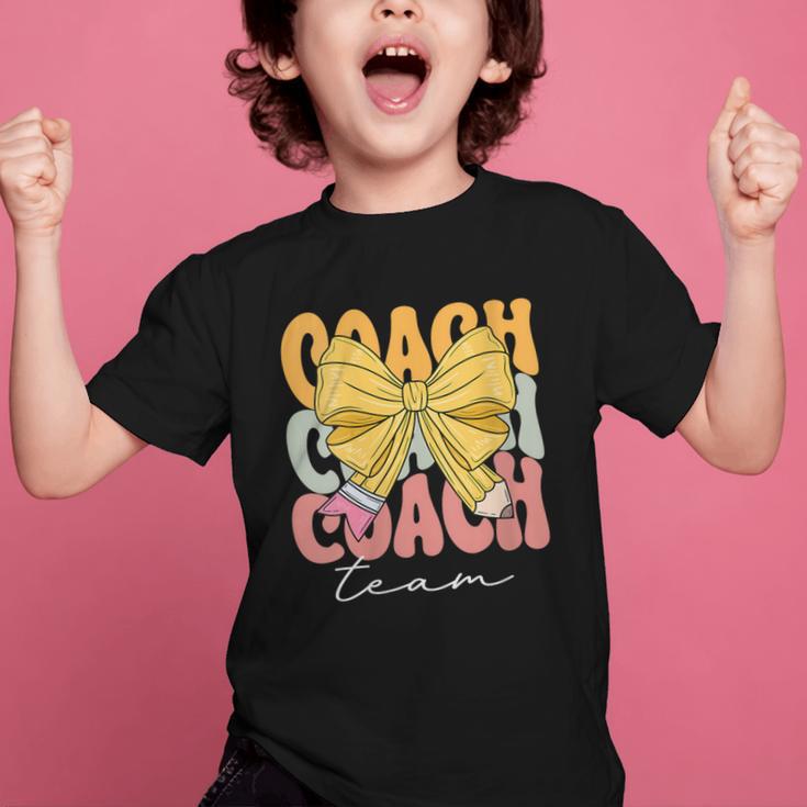 Coach Team Groovy Coquette Bow Cute Back To School Graphic Kid T-Shirt Coach Team Groovy Coquette Bow Cute Back To School Graphic Kid T-Shirt