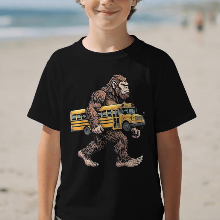 Bigfoot Carrying School Bus Sasquatch Back To School Graphic Kid T-Shirt Bigfoot Carrying School Bus Sasquatch Back To School Graphic Kid T-Shirt
