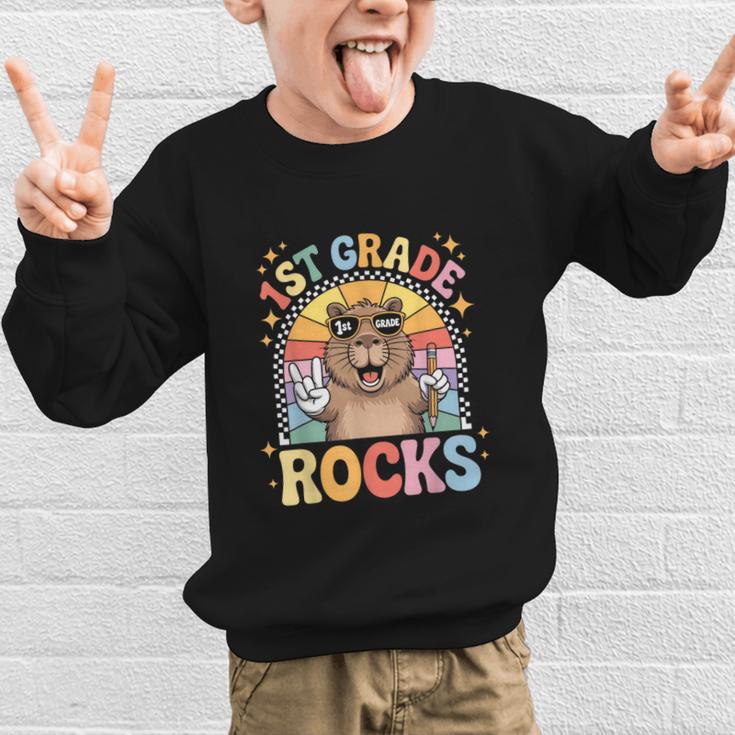 Back To School 1st Grade Capybara First Grade Rocks Graphic Kid Sweatshirt Back To School 1st Grade Capybara First Grade Rocks Graphic Kid Sweatshirt