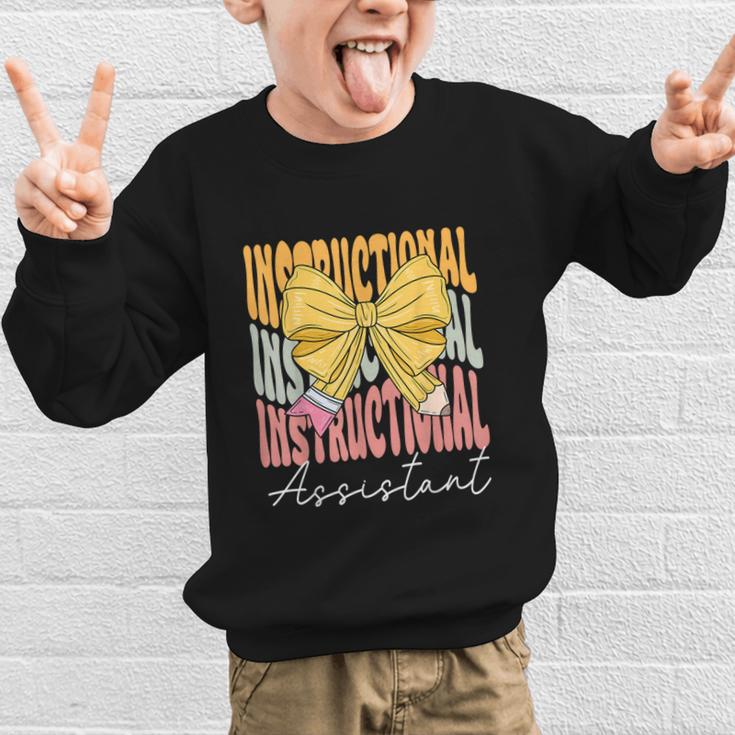 Instructional Assistant Groovy Coquette Bow Back To School Graphic Kid Sweatshirt Instructional Assistant Groovy Coquette Bow Back To School Graphic Kid Sweatshirt