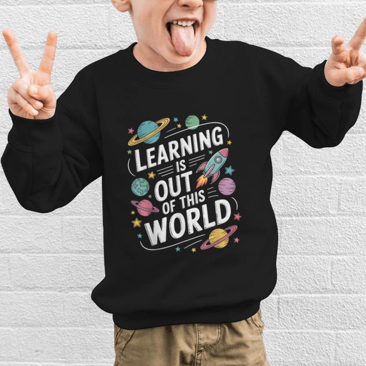 Learning Is Out Of This World Back To School Graphic Kid Sweatshirt Learning Is Out Of This World Back To School Graphic Kid Sweatshirt