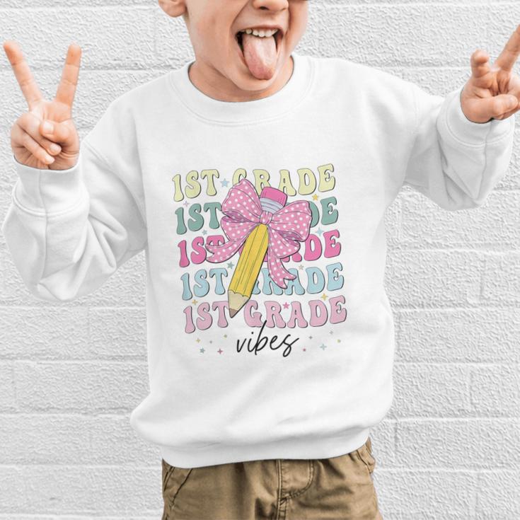 1st Grade Vibes Girl Coquette Bow First Grade Back To School Graphic Kid Sweatshirt 1st Grade Vibes Girl Coquette Bow First Grade Back To School Graphic Kid Sweatshirt