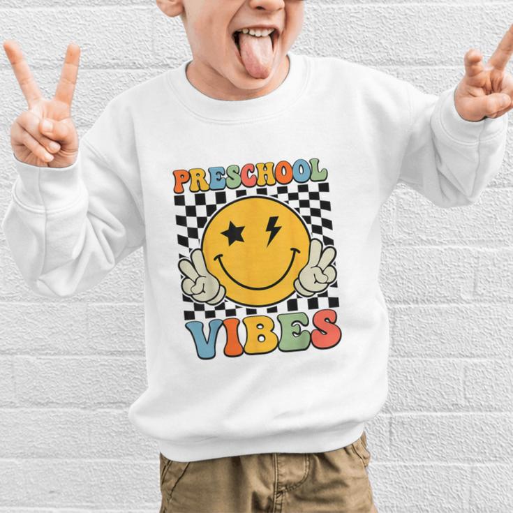 Preschool Vibes Retro Groovy Back To School Pre-K Graphic Kid Sweatshirt Preschool Vibes Retro Groovy Back To School Pre-K Graphic Kid Sweatshirt