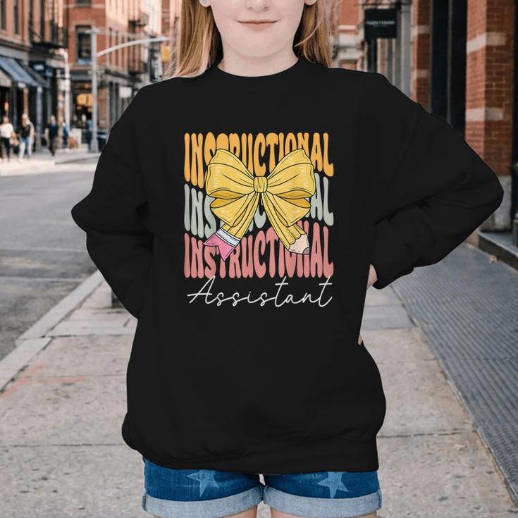 Instructional Assistant Groovy Coquette Bow Back To School Youth Crewneck Sweatshirt Instructional Assistant Groovy Coquette Bow Back To School Youth Crewneck Sweatshirt