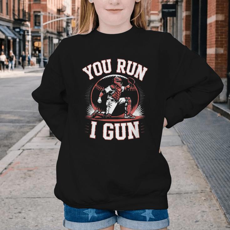 You Run I Gun Baseball Catcher Softball Player Youth Crewneck Sweatshirt You Run I Gun Baseball Catcher Softball Player Youth Crewneck Sweatshirt