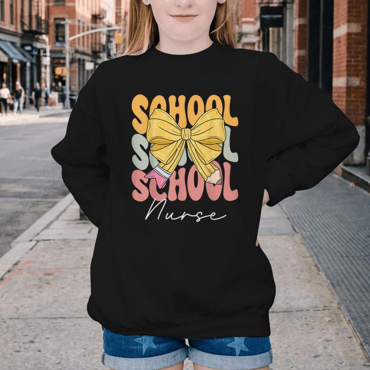 School Nurse Groovy Coquette Bow Cute Back To School Youth Crewneck Sweatshirt School Nurse Groovy Coquette Bow Cute Back To School Youth Crewneck Sweatshirt