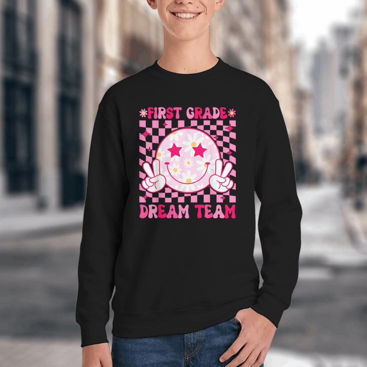 Groovy First Grade Dream Team Back To School 1st Grade Squad Youth Crewneck Sweatshirt Groovy First Grade Dream Team Back To School 1st Grade Squad Youth Crewneck Sweatshirt