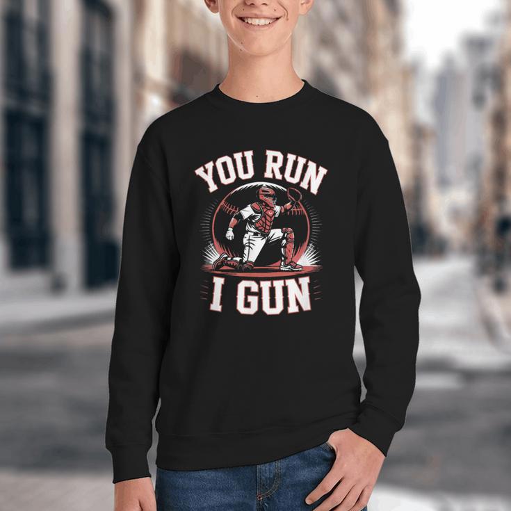 You Run I Gun Baseball Catcher Softball Player Youth Crewneck Sweatshirt You Run I Gun Baseball Catcher Softball Player Youth Crewneck Sweatshirt