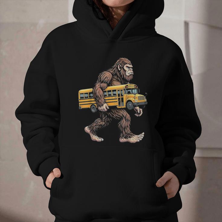 Bigfoot Carrying School Bus Sasquatch Back To School Graphic Youth Hoodie