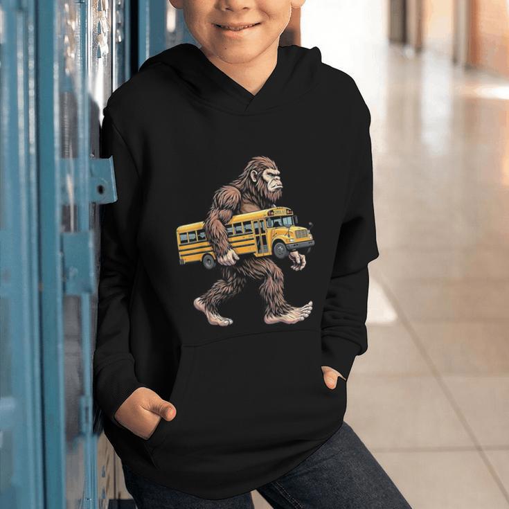 Bigfoot Carrying School Bus Sasquatch Back To School Graphic Youth Hoodie