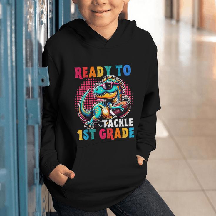 First Day Back To School 1st Grade Boys Football Dinosaur Graphic Youth Hoodie First Day Back To School 1st Grade Boys Football Dinosaur Graphic Youth Hoodie