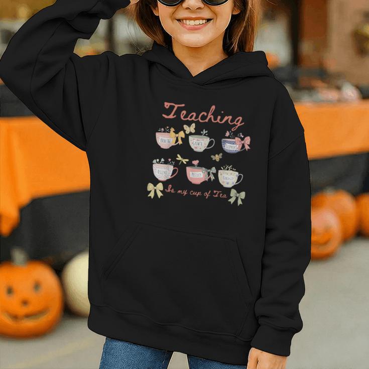 Teaching Is My Cup Of Tea Coquette Bow Floral Back To School Graphic Youth Hoodie Teaching Is My Cup Of Tea Coquette Bow Floral Back To School Graphic Youth Hoodie