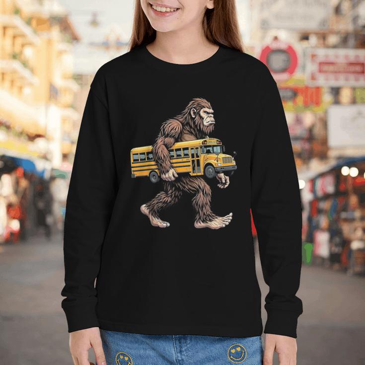 Bigfoot Carrying School Bus Sasquatch Back To School Youth Long Sleeve Tee Bigfoot Carrying School Bus Sasquatch Back To School Youth Long Sleeve Tee