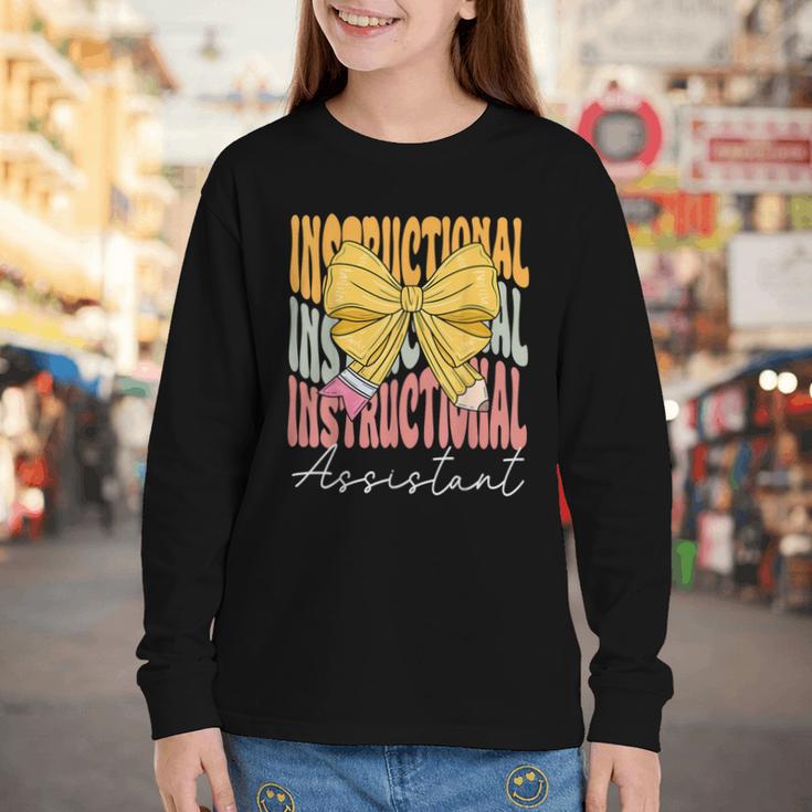 Instructional Assistant Groovy Coquette Bow Back To School Youth Long Sleeve Tee Instructional Assistant Groovy Coquette Bow Back To School Youth Long Sleeve Tee