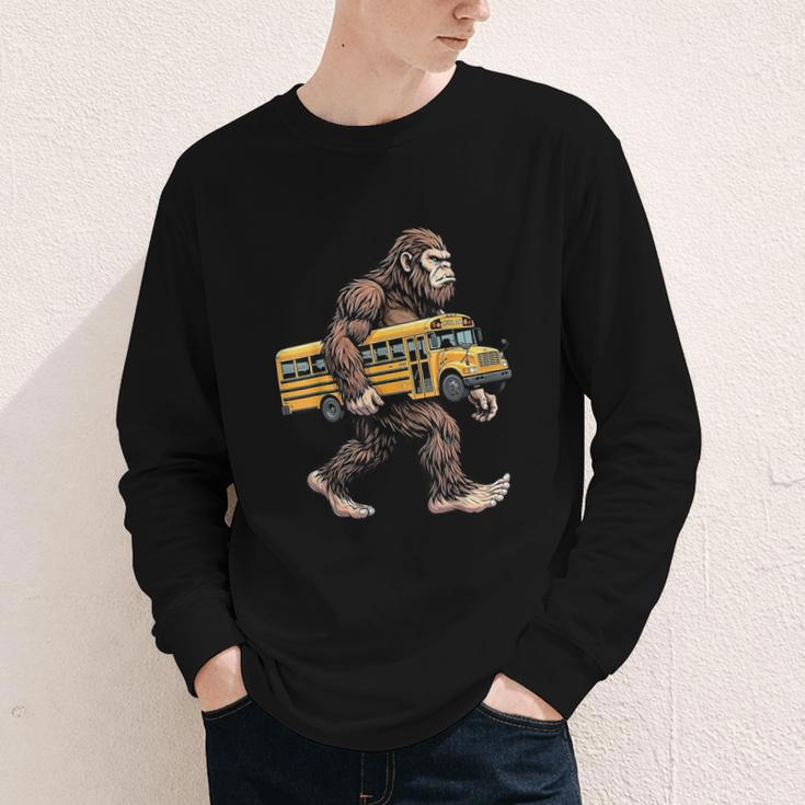 Bigfoot Carrying School Bus Sasquatch Back To School Youth Long Sleeve Tee Bigfoot Carrying School Bus Sasquatch Back To School Youth Long Sleeve Tee