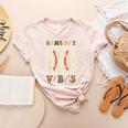 Women Kids Baseball Game Day Vibes Smile Baseball Mom Women's Heather T-Shirt Heather Peach Women Kids Baseball Game Day Vibes Smile Baseball Mom Women's Heather T-Shirt Heather Peach