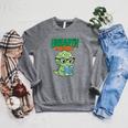 Women's Unearth a Story Summer Reading 2026 Triceratops Dino Book Raglan Sleeve Sweatshirt Deep Heather