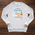 A Book A Day Keeps Reality Away Keep Your Day Dream Raglan Sleeve Sweatshirt Heather Mustard
