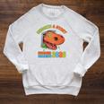 Unearth A Story Summer Reading 2026 Dinosaur Book Lover Dino Premium Tri-Blend Raglan Sleeve Sweatshirt Heather Mustard